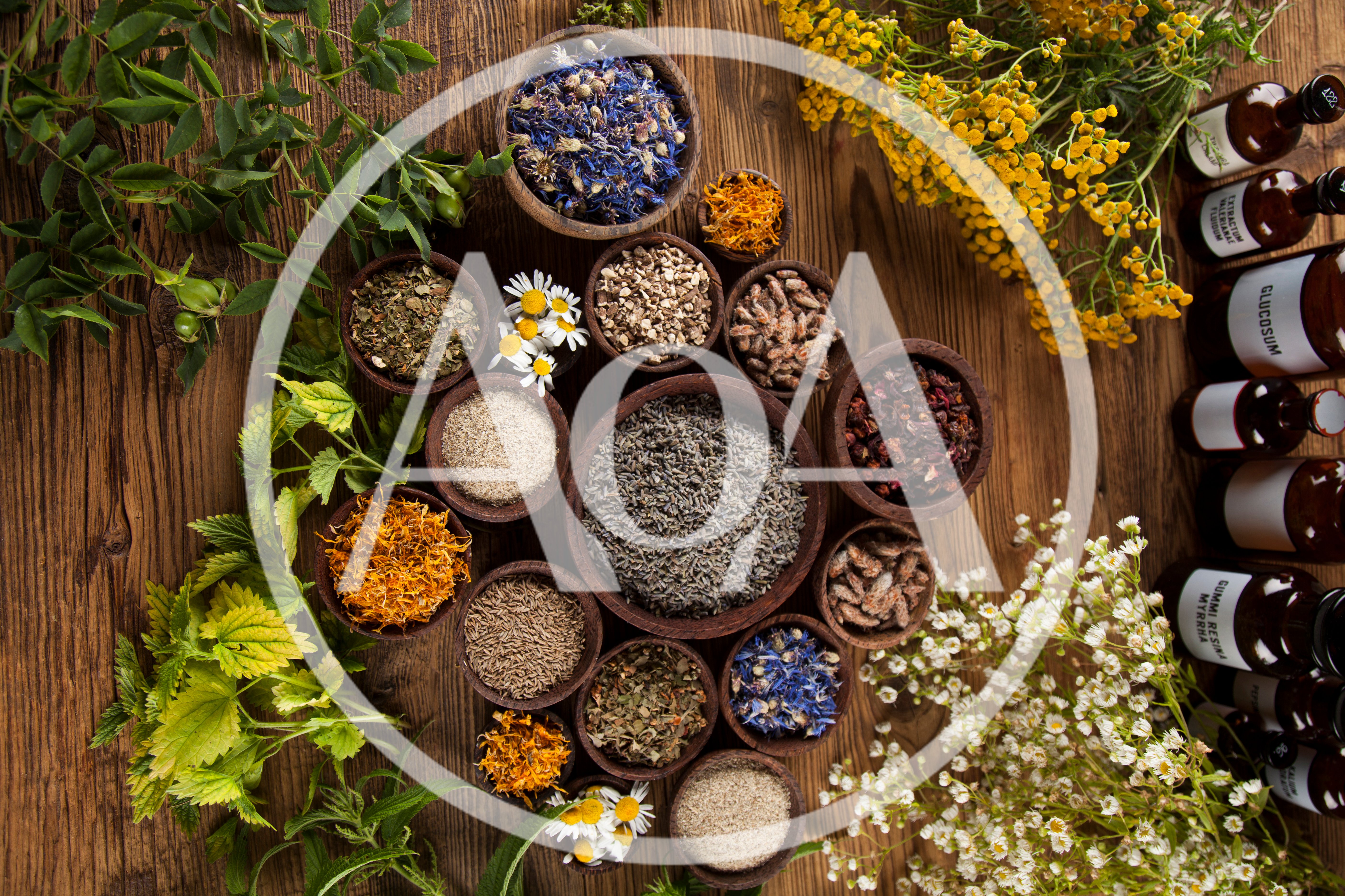 Assorted Dried Herbs And Flowers In Wooden Bowls