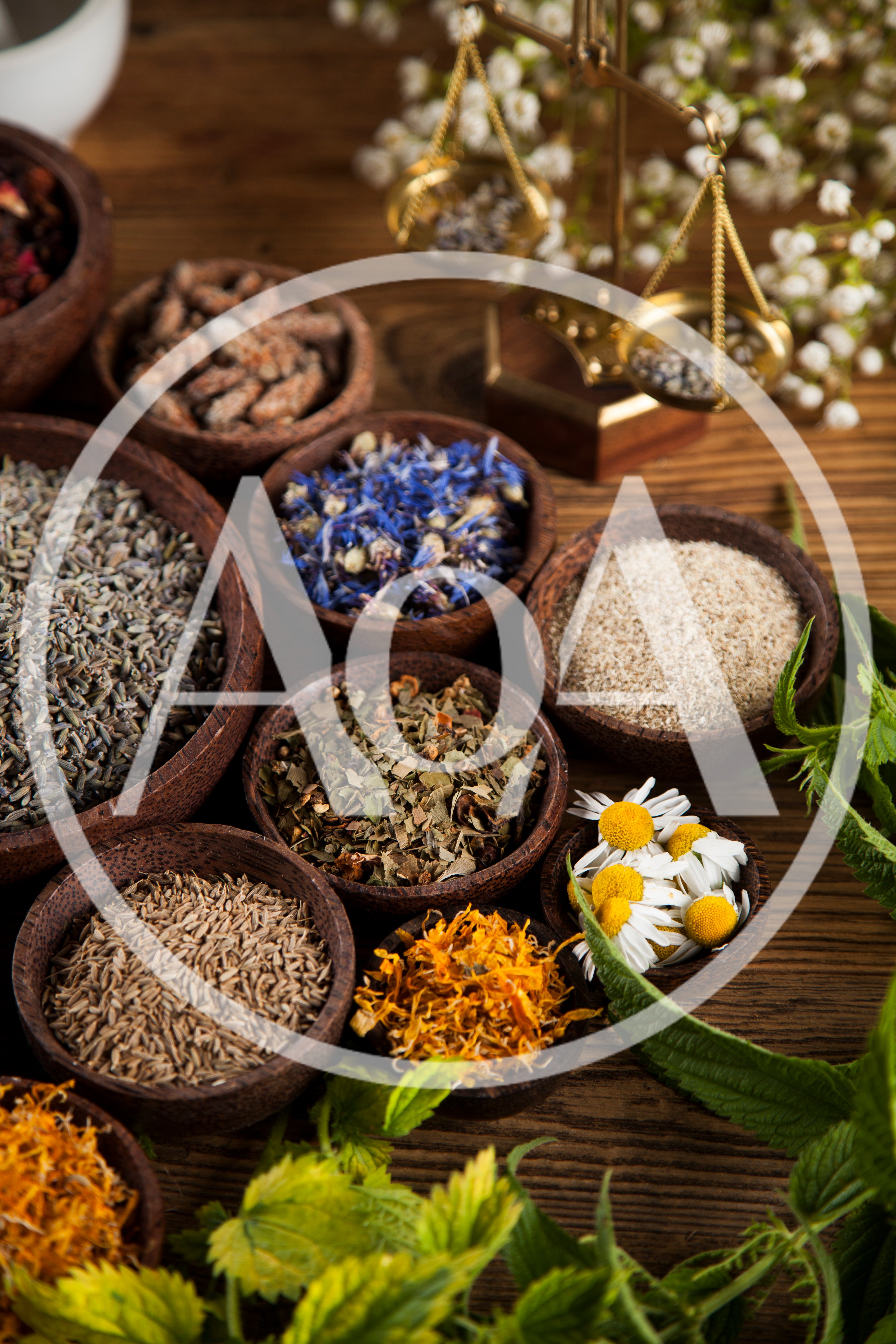 Assorted Dried Herbs And Flowers In Wooden Bowls