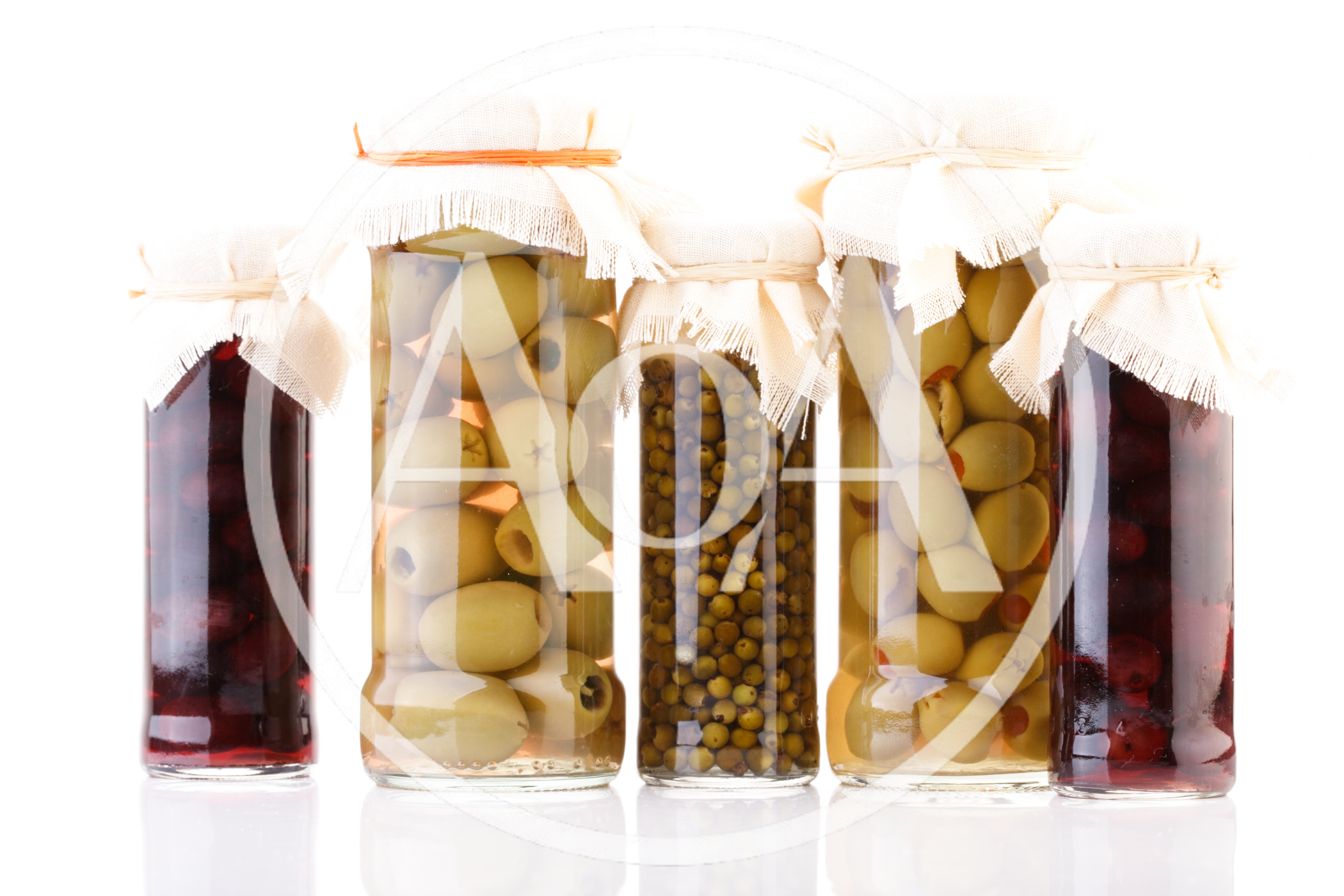 Five Glass Jars Filled With Pickled Vegetables And Fruits