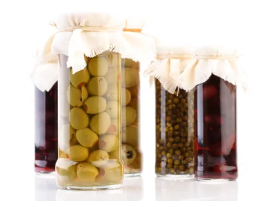 Glass Jars Filled With Pickled Olives And Capers