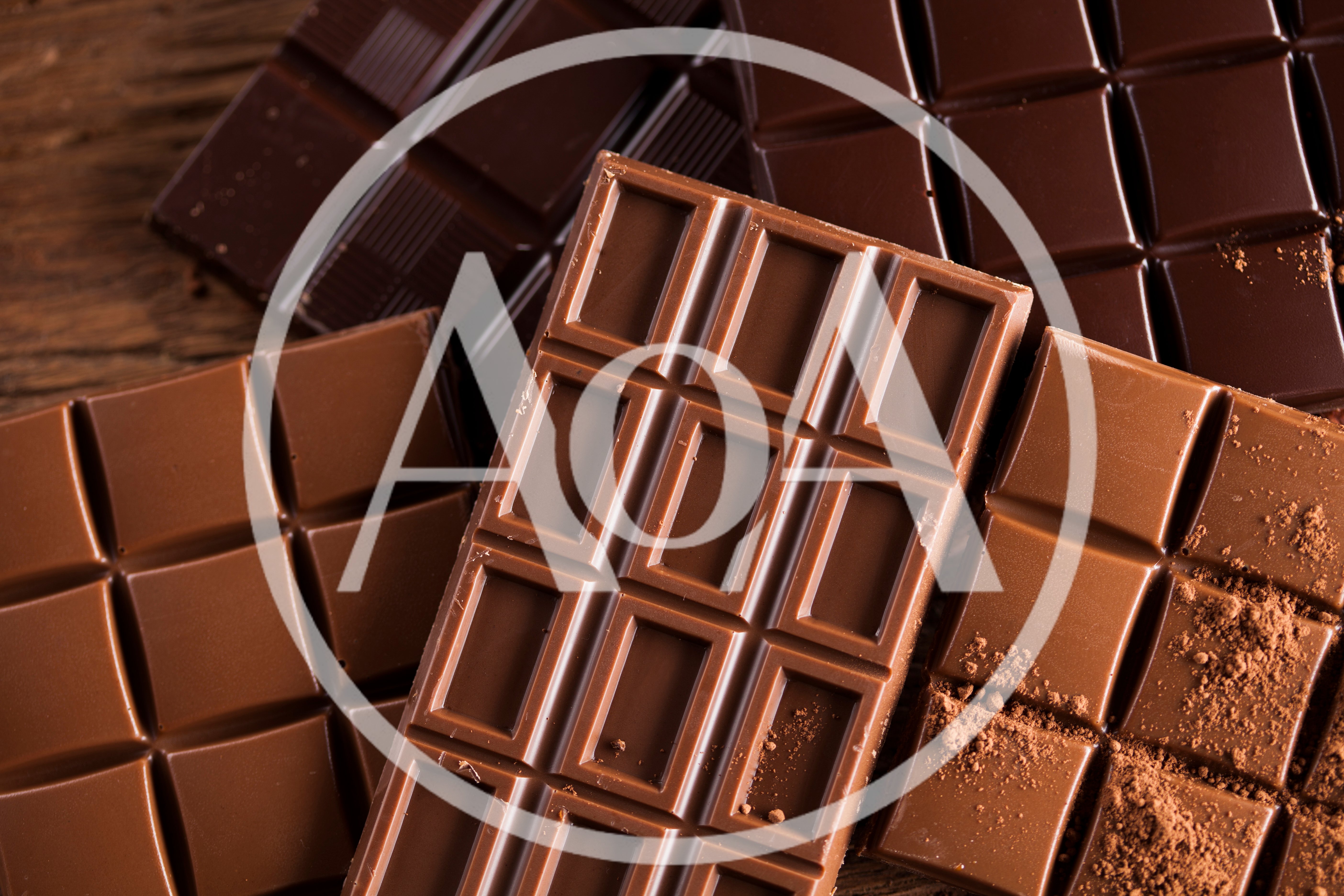 Assorted Chocolate Bars On A Rustic Wooden Surface