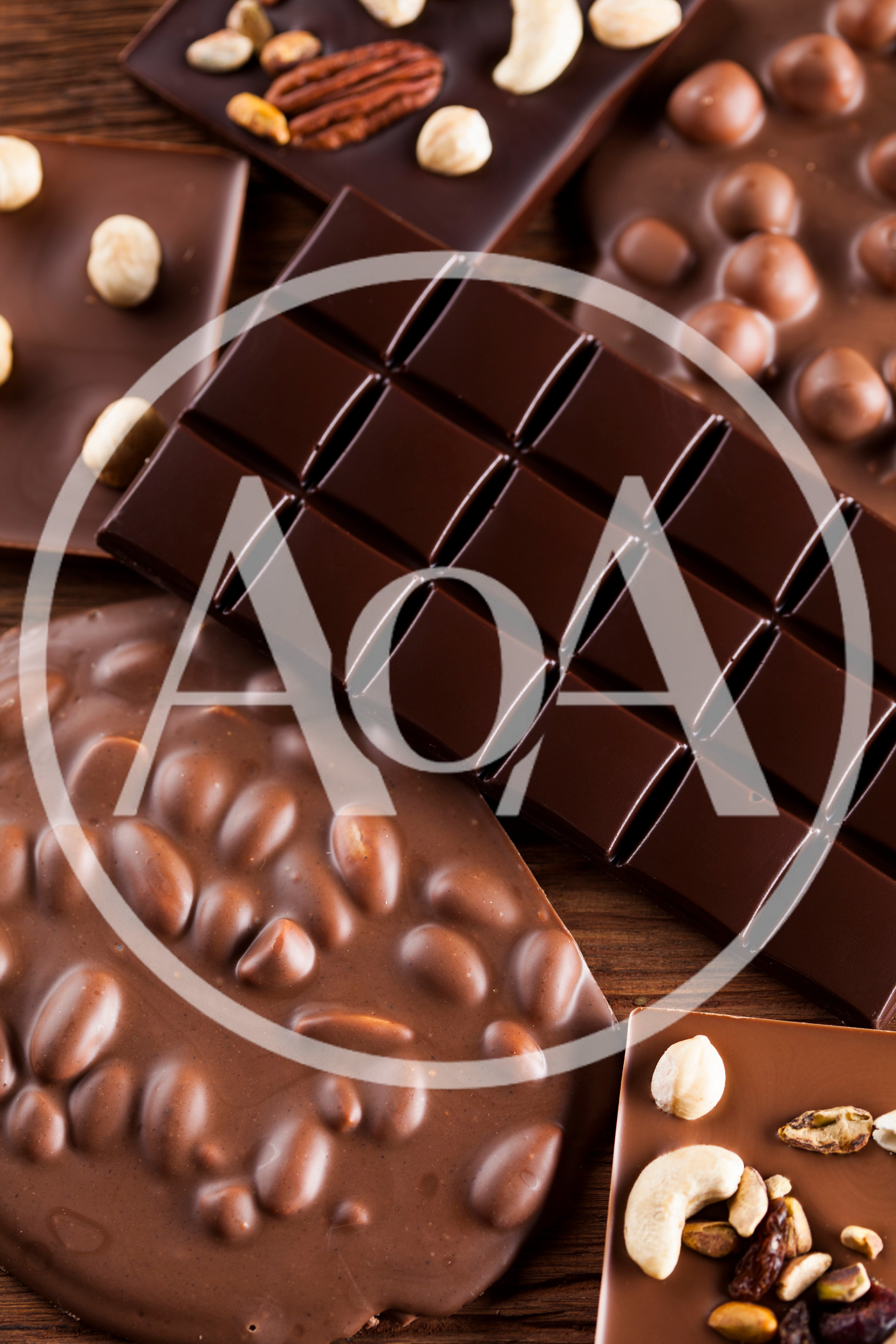 Assorted Chocolate Bars With Nuts On Wooden Background