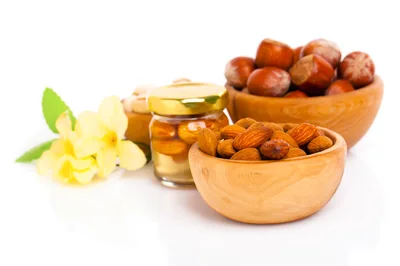 Wooden Bowls Filled With Almonds And Hazelnuts