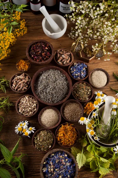 Assorted Dried Herbs And Spices In Wooden Bowls