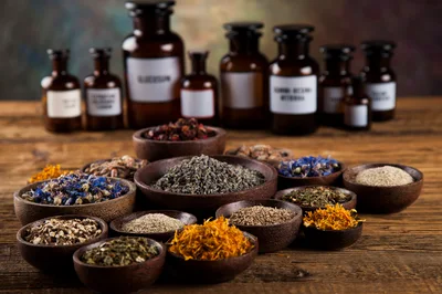 Assorted Dried Herbs and Spices in Wooden Bowls