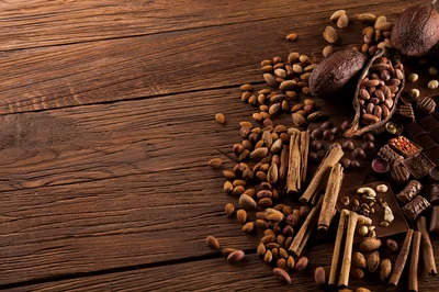 Cocoa Beans And Chocolate On Wooden Table