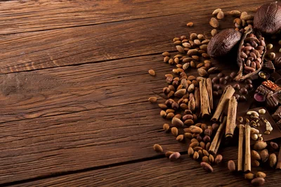 Cocoa Beans and Cinnamon Sticks on Wooden Table