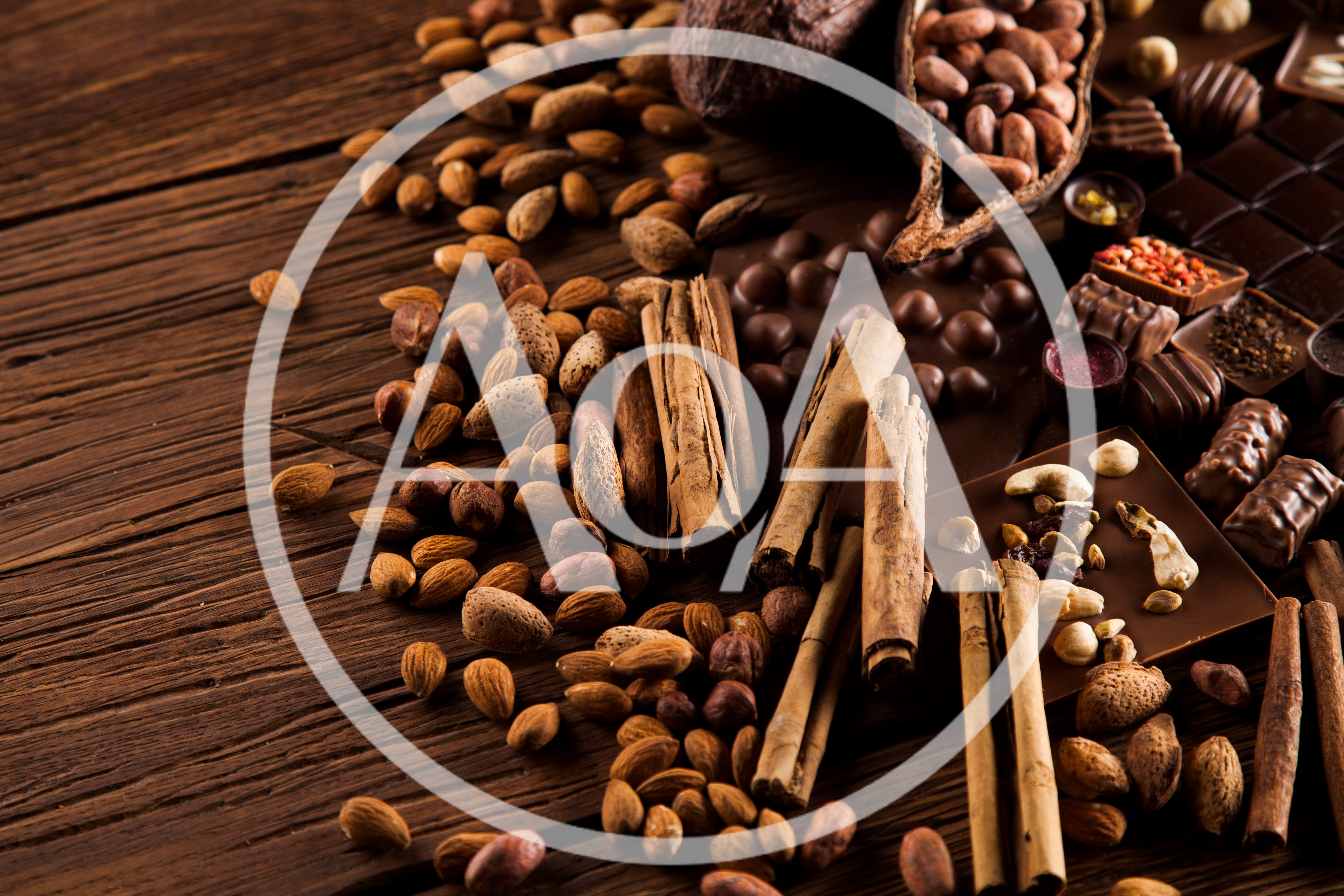 Assorted Nuts Spices And Chocolate On Wooden Table