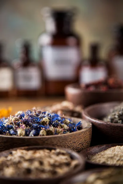 Assorted Dried Medicinal Herbs In Wooden Bowls