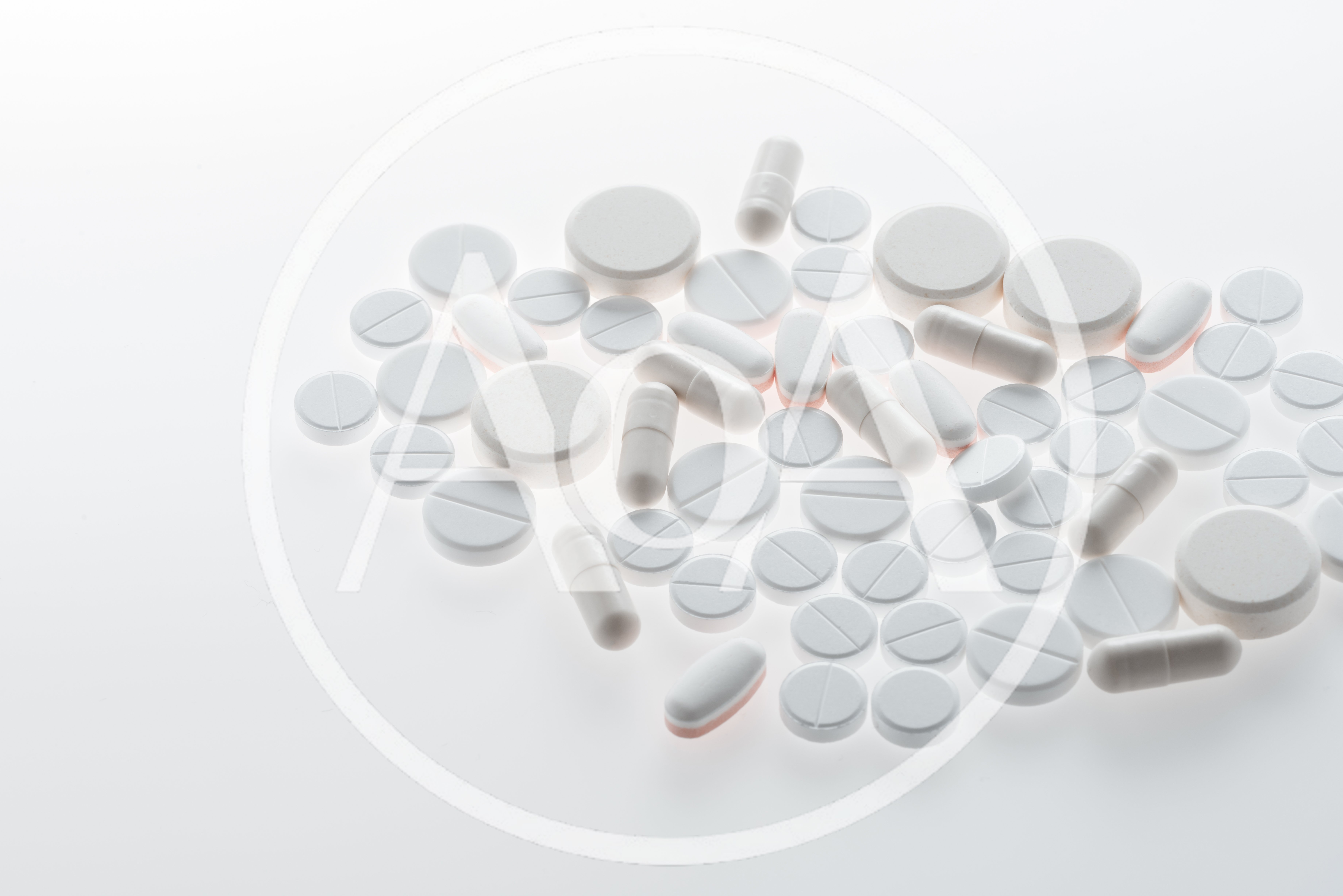 Assorted White Medical Pills And Capsules On White Background