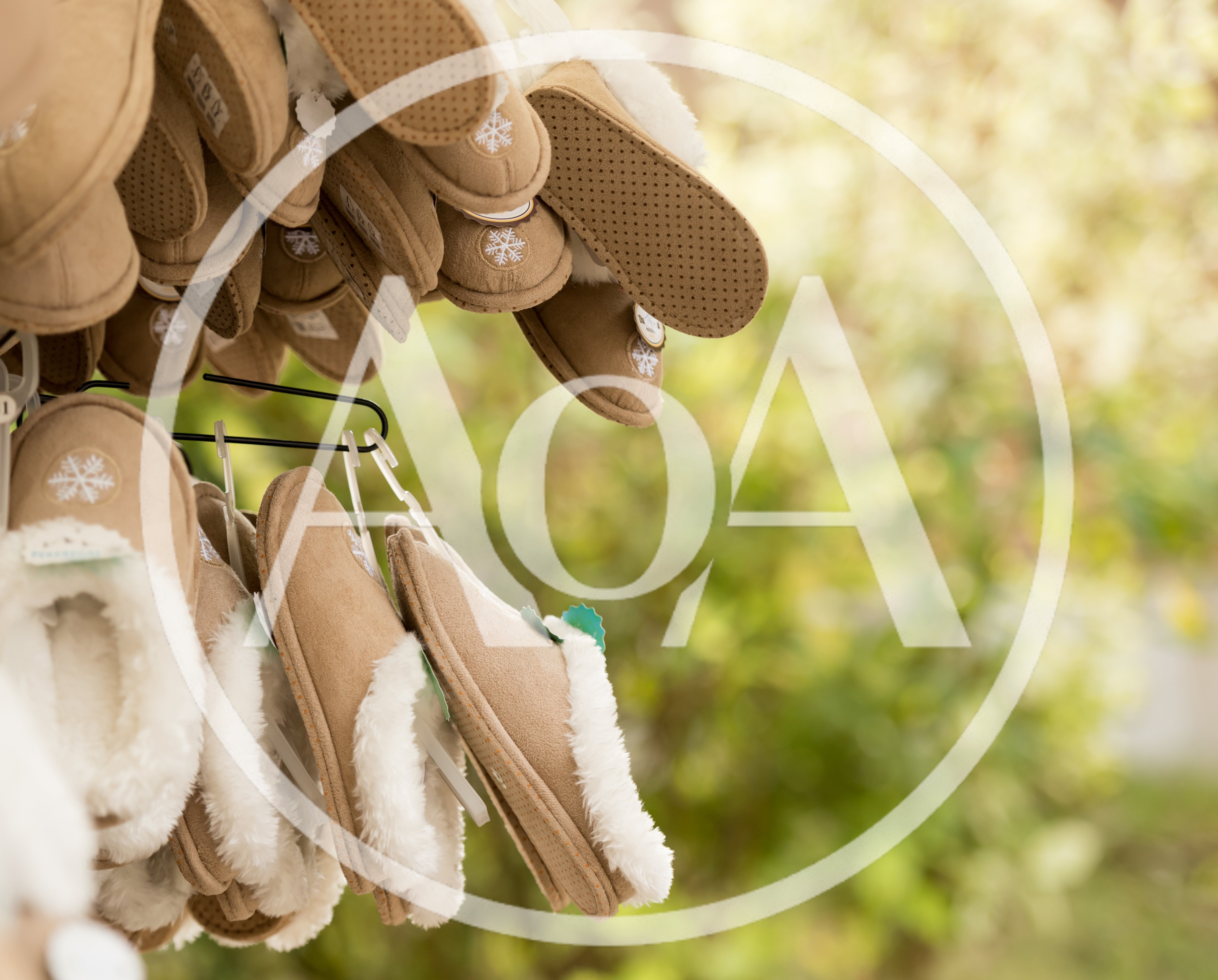 Tan Suede Slippers Hanging On A Retail Display Rack