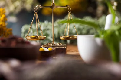 Golden Balance Scale With Medicinal Herbs And Mortar