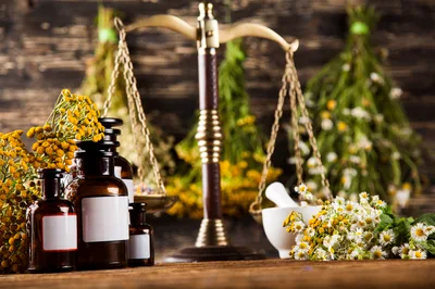 Herbal Medicine Bottles And Scales On Wooden Table