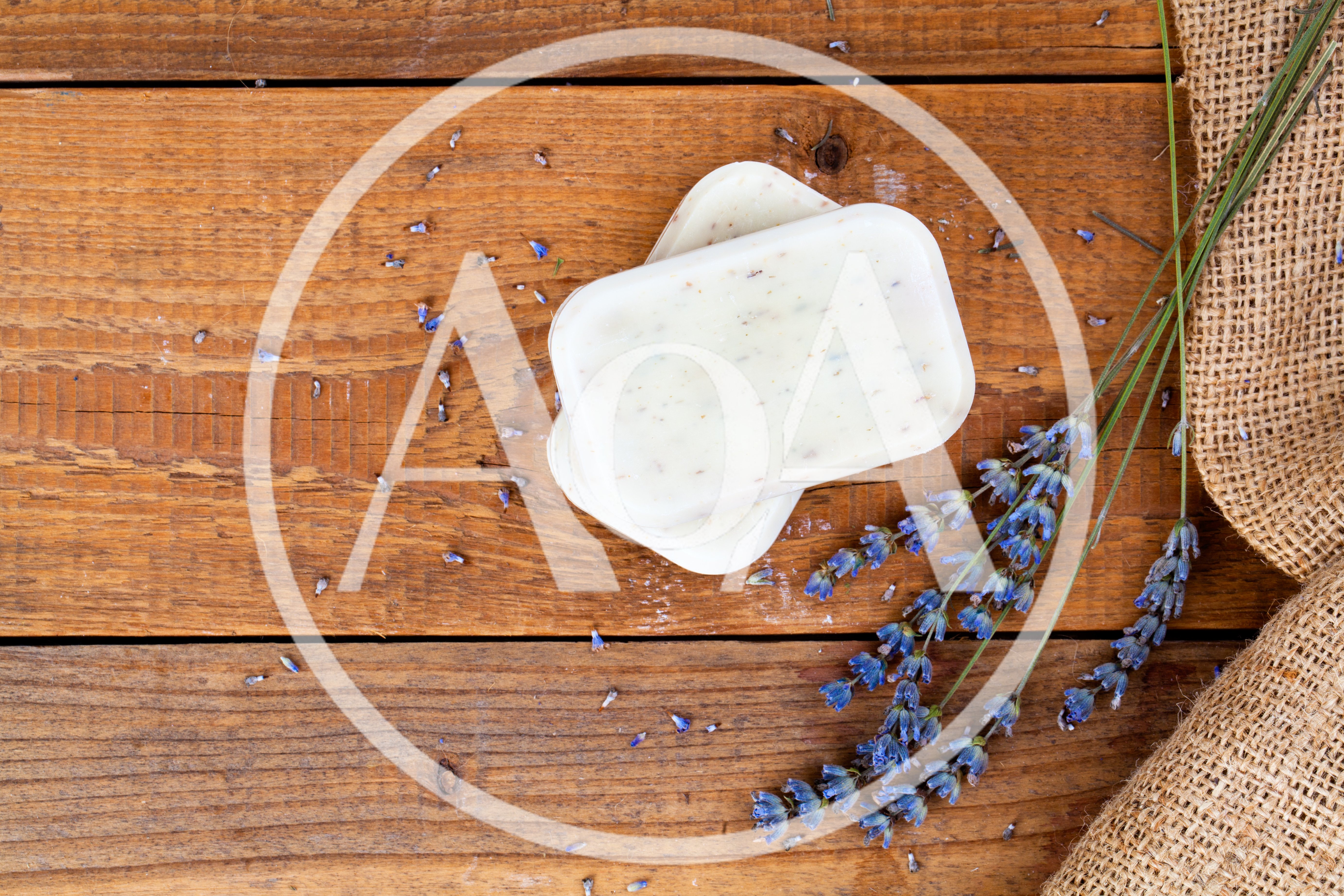 Two Bars Of Lavender Soap On Rustic Wooden Table