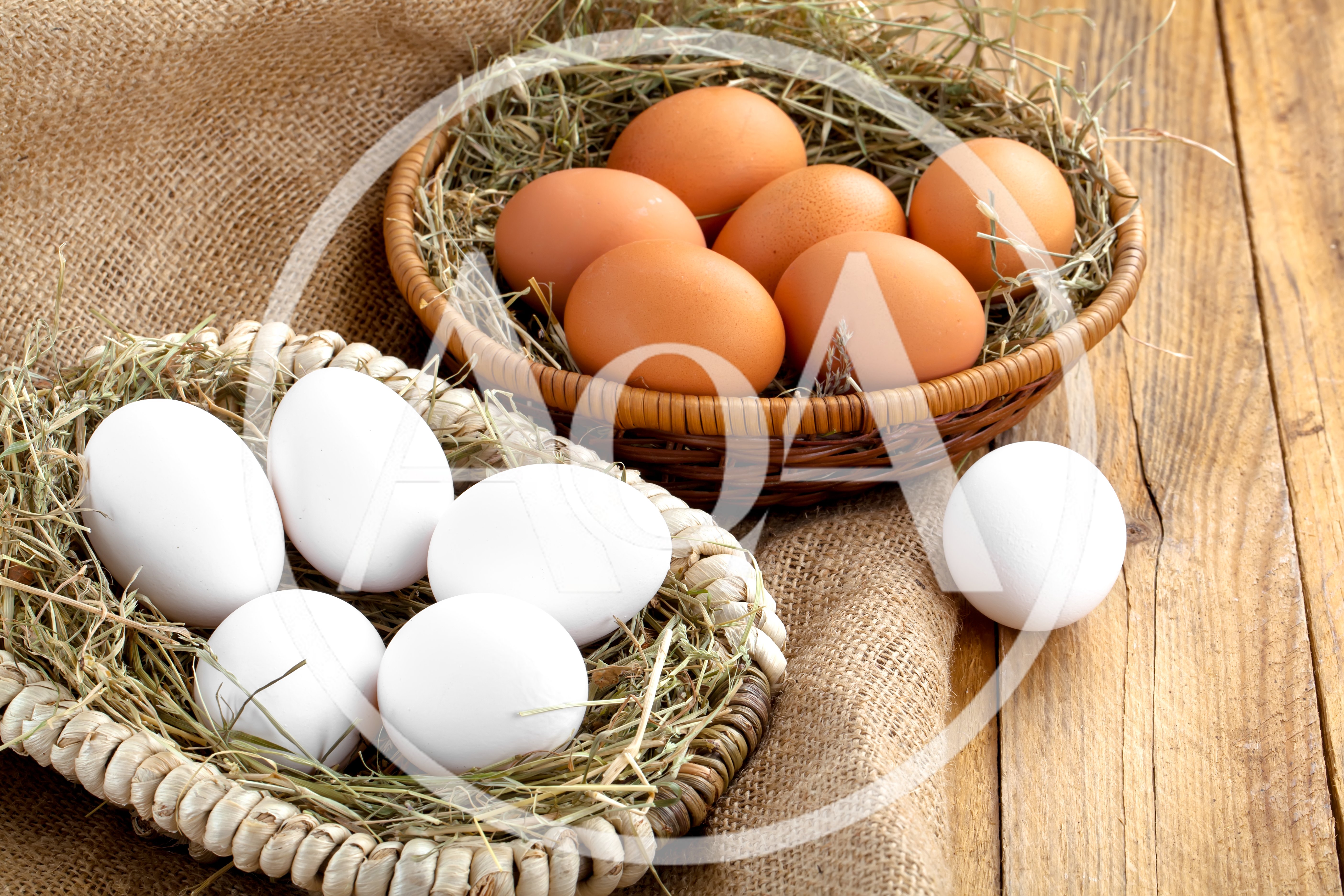 Fresh Brown And White Eggs In Woven Baskets
