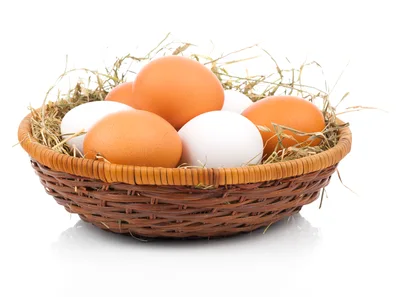 Fresh Brown and White Eggs in Wicker Basket