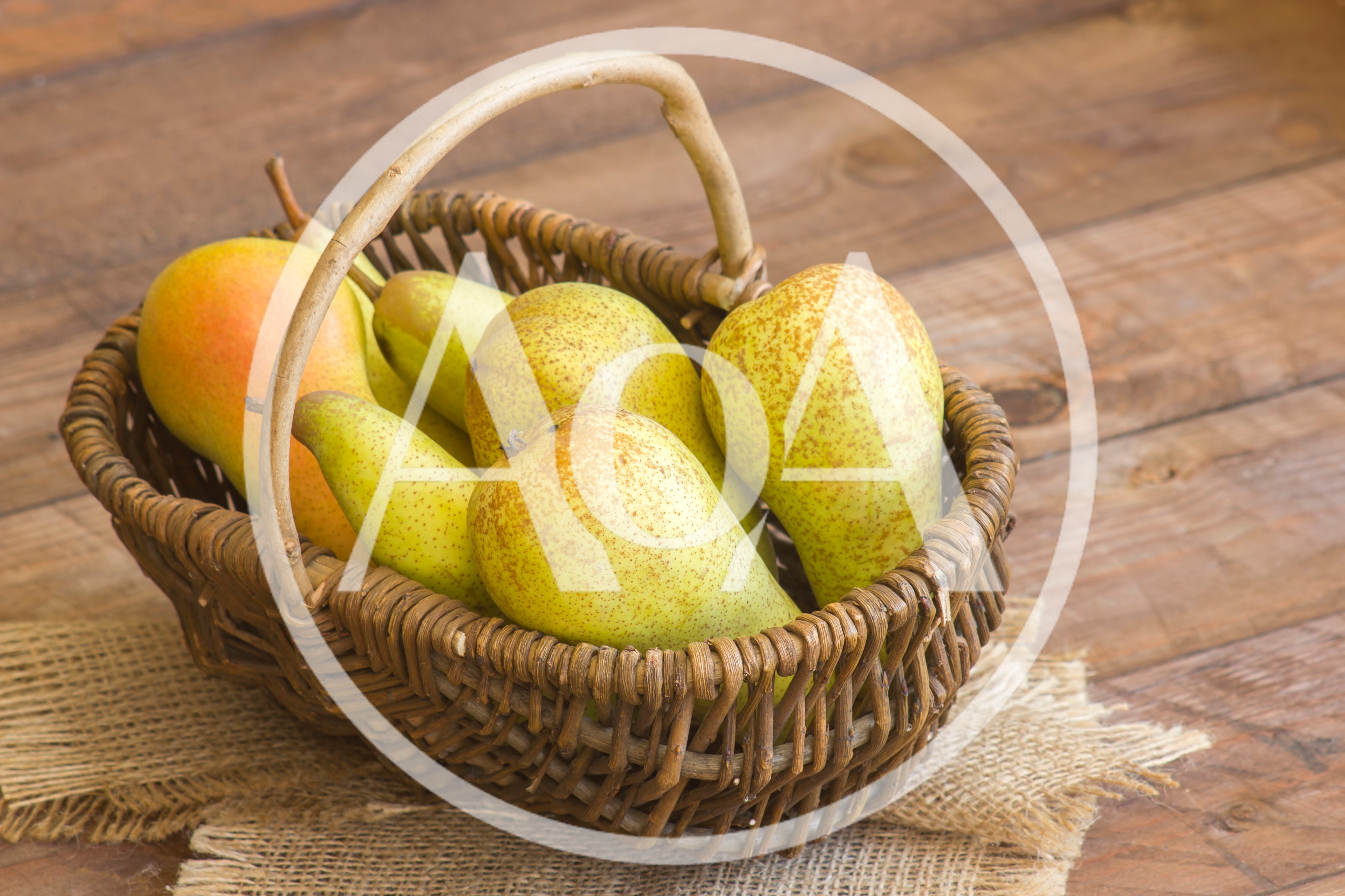 Fresh Pears In A Wicker Basket On Wooden Table