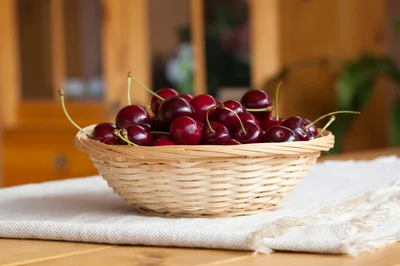 Fresh Red Cherries In A Woven Basket