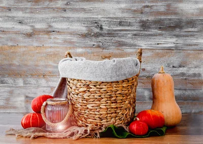 Woven Basket With Pumpkins And Lantern On Wooden Background