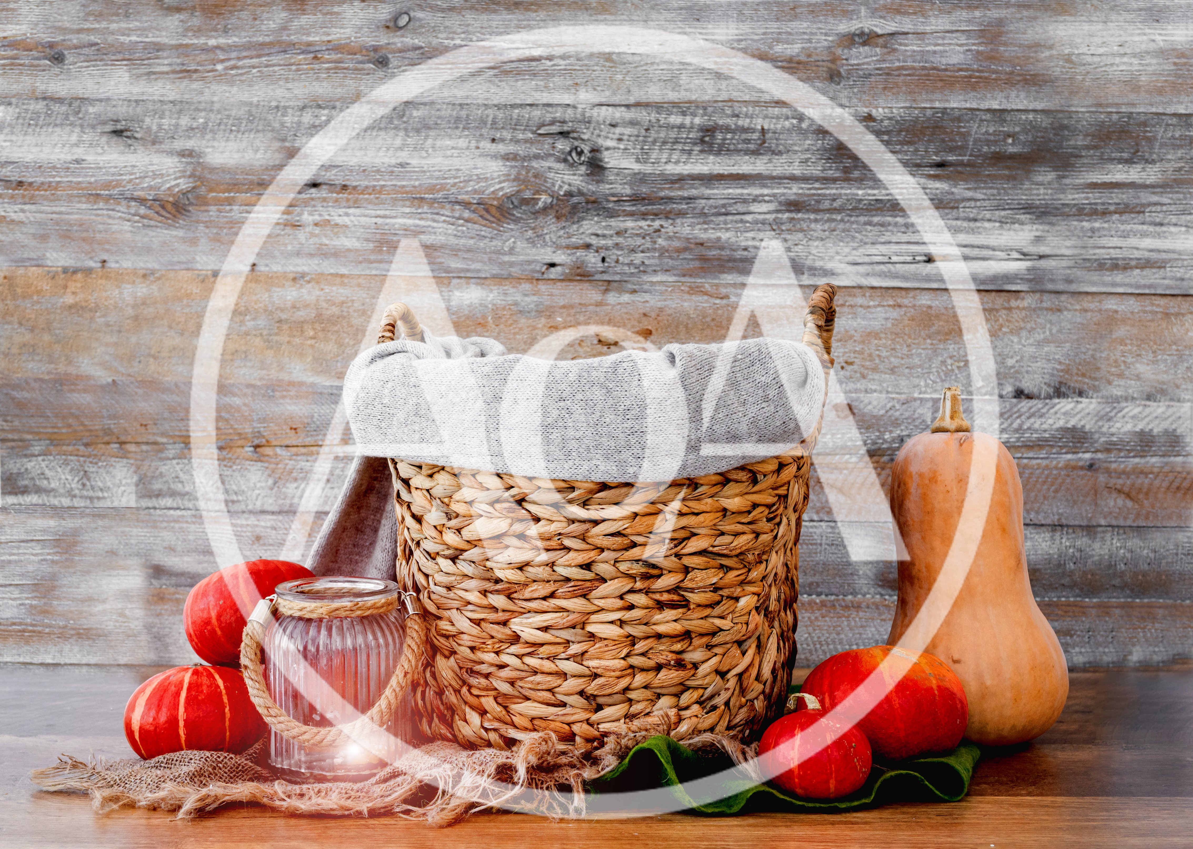Woven Basket With Pumpkins And Lantern On Wooden Background