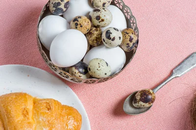 Quail Eggs And Croissant On A Pink Tablecloth