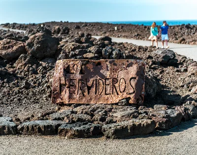 Rusty Los Hervideros Sign In Lanzarote Volcanic Landscape