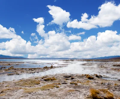 Geothermal Steam Rising From Volcanic Landscape
