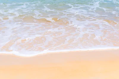 Gentle Ocean Waves Washing Over Sandy Beach