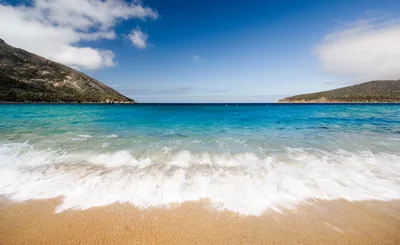 Waves Crashing On A Sunny Beach At Wineglass Bay