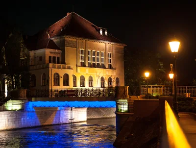 Illuminated Historic Building And Bridge At Night