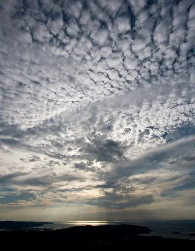 Dramatic Altocumulus Clouds Over A Coastal Landscape