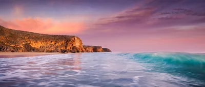 Dramatic Sunset Over Rugged Coastal Cliffs And Ocean