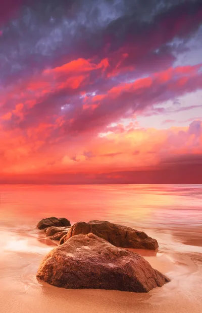 Dramatic Sunset Over Tropical Beach With Large Rocks