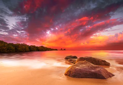 Dramatic Sunset Over Tropical Beach With Large Rocks