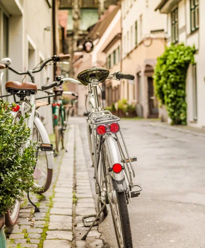Bicycles Parked On A Cobblestone Street In A European Town