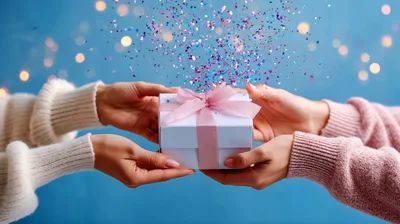 Two People Exchanging A Gift Box With Confetti