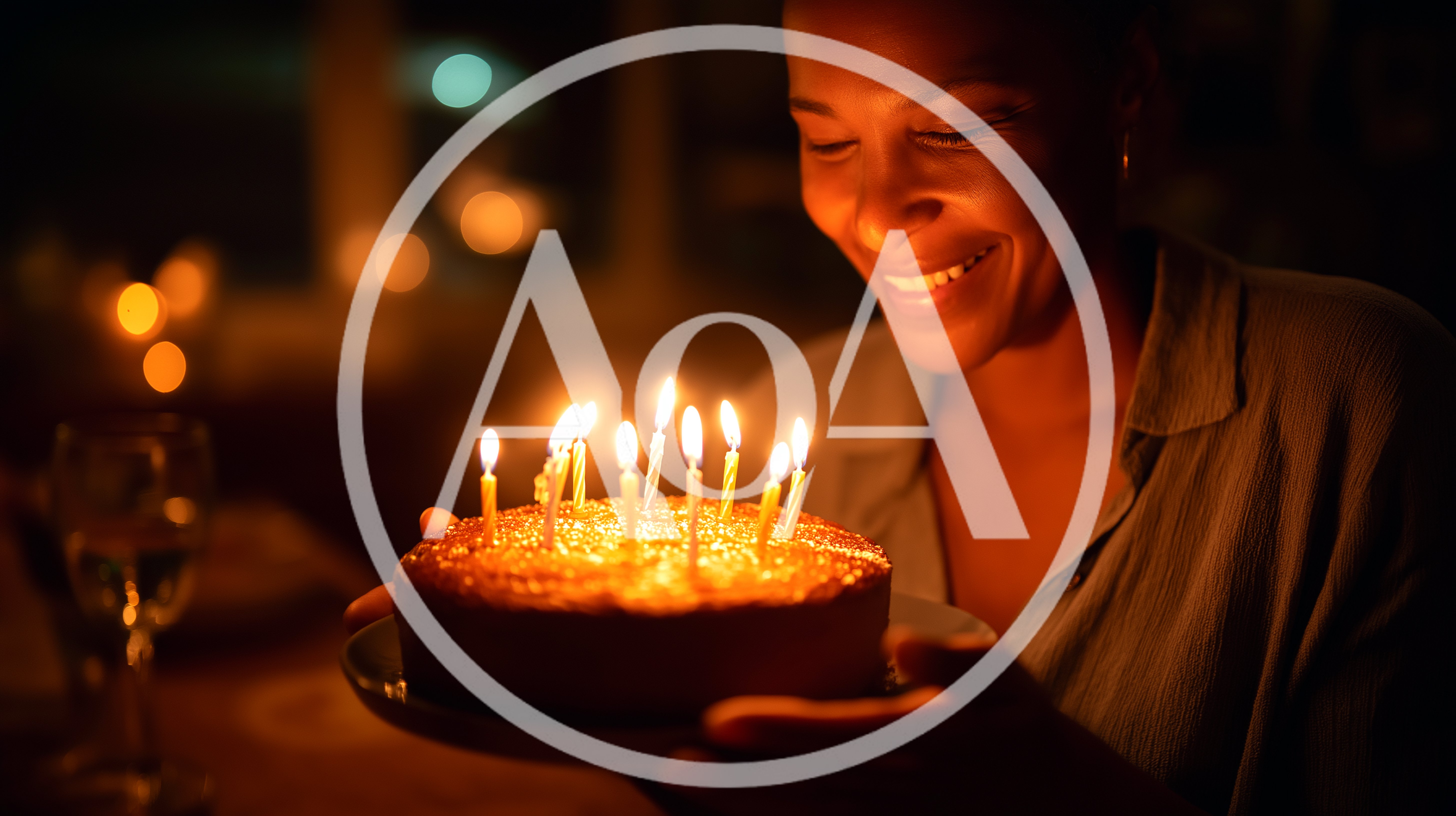 Woman Smiling At Birthday Cake With Lit Candles