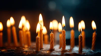 Burning Birthday Candles On A Dark Cake
