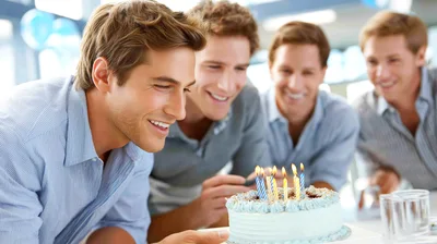 Group Of Men Celebrating Birthday With Cake