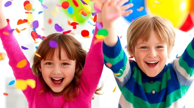 Happy Children Celebrating With Confetti And Balloons