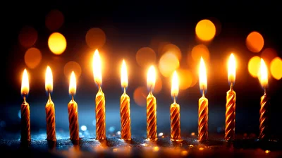 Ten Burning Birthday Candles Against A Dark Bokeh Background