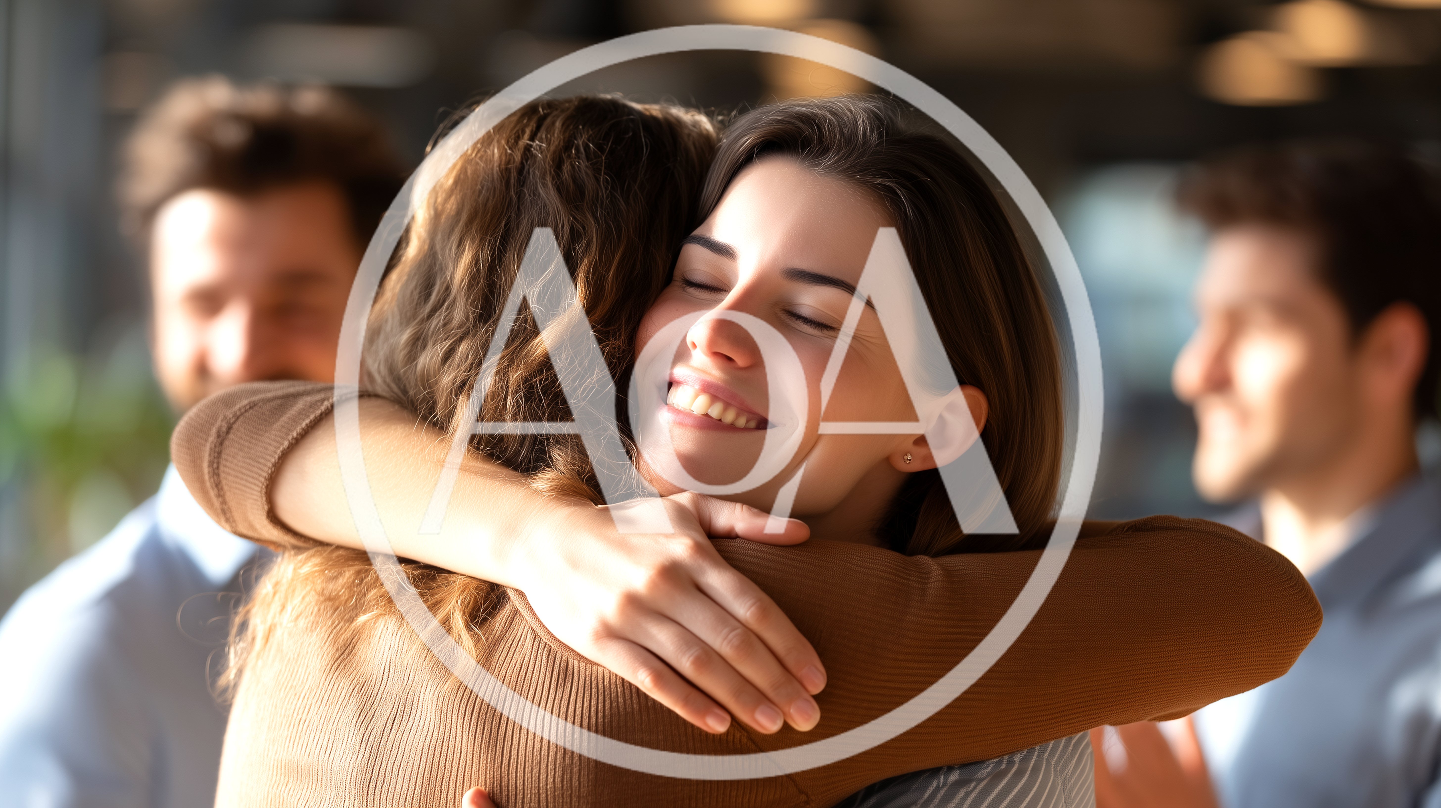Two Women Embracing Warmly In A Professional Office Setting
