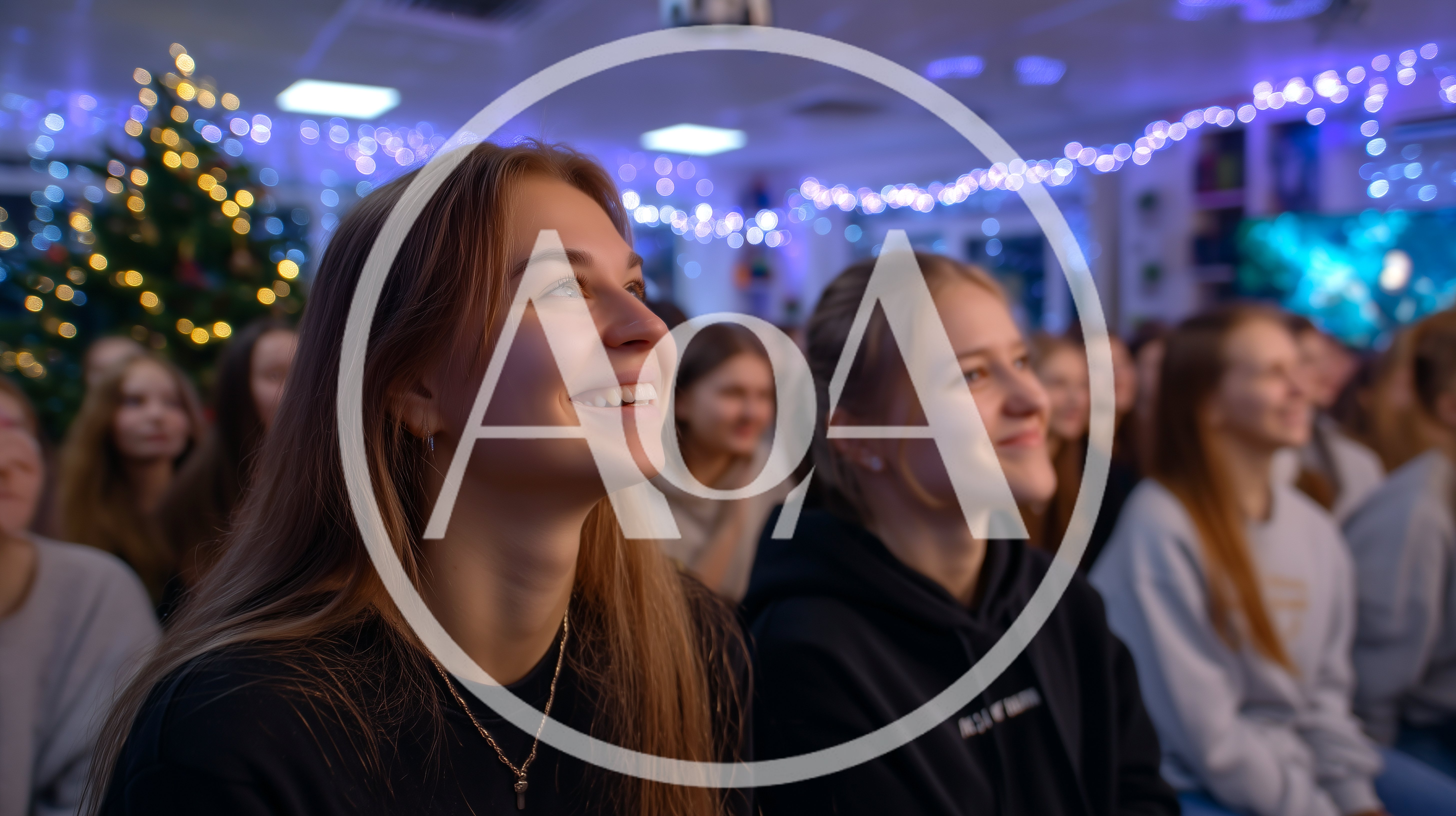 Young Women Watching Presentation in Festive Decorated Hall