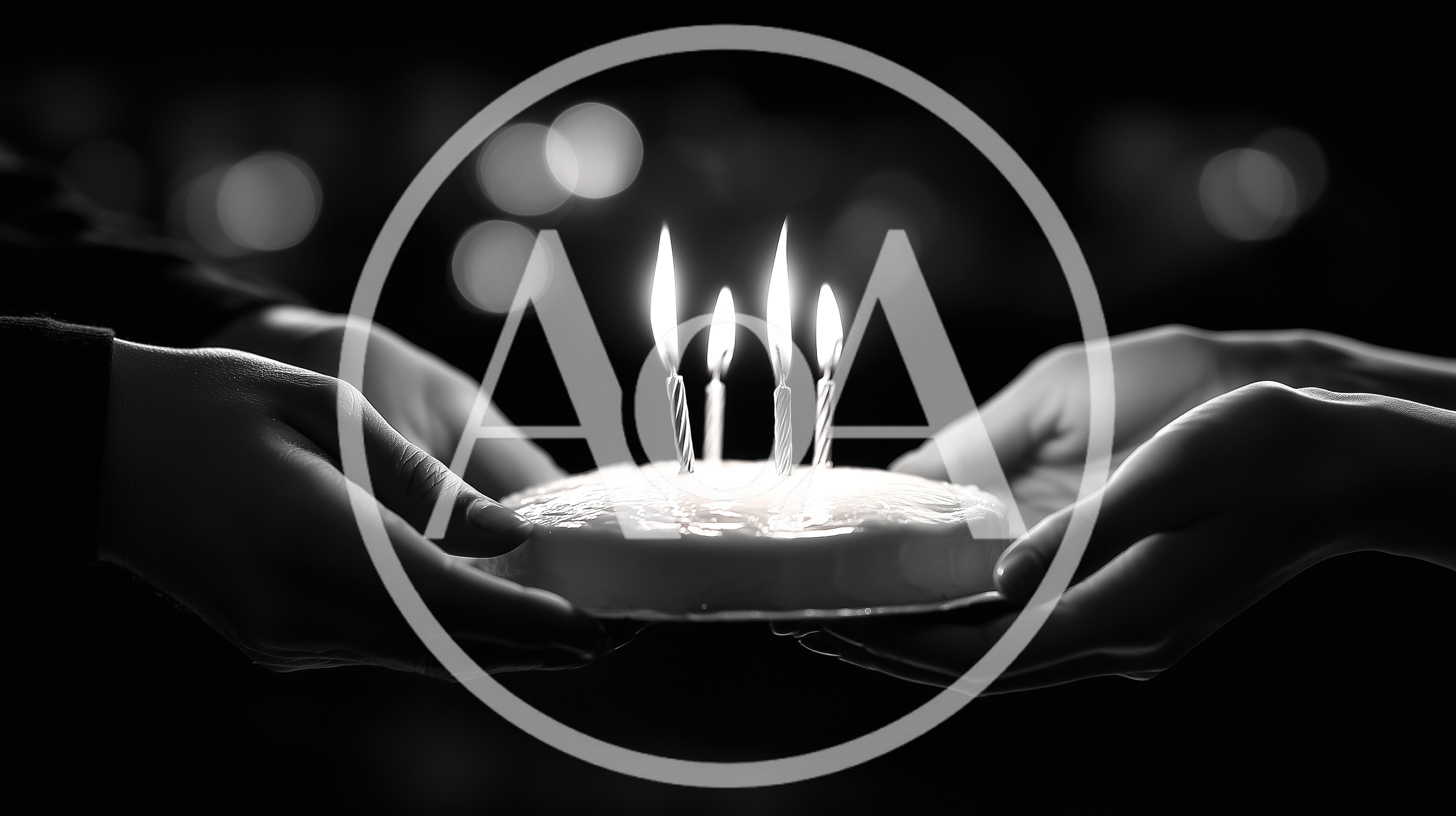 Two People Holding A Birthday Cake With Lit Candles