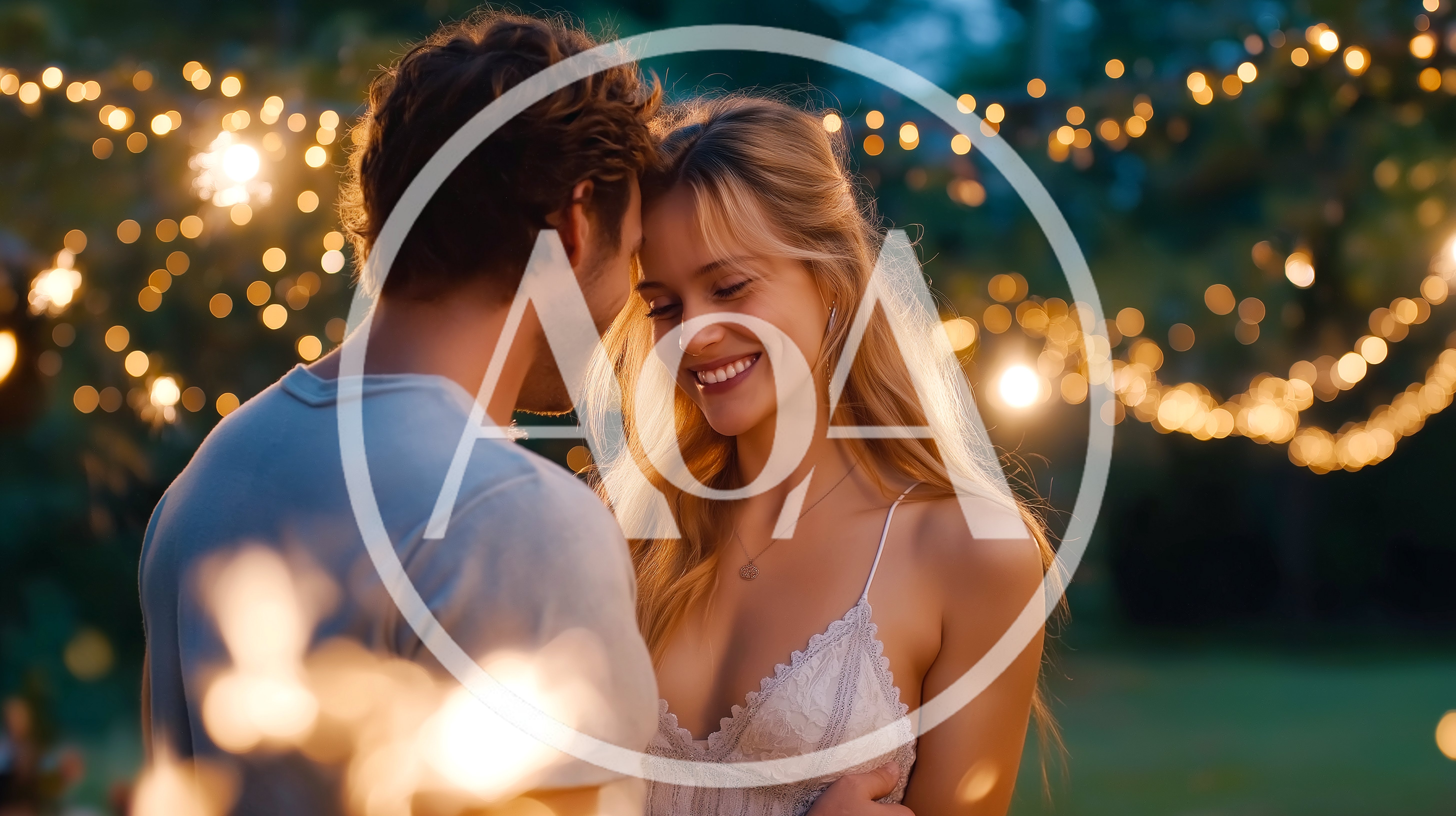 Young Couple Embracing Outdoors Under Fairy Lights