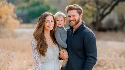 Happy Young Family Posing Together Outdoors
