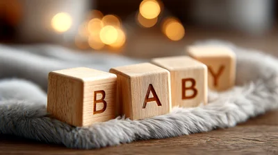Wooden Baby Blocks Spelling Baby On Soft Grey Fabric