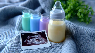 Baby Bottles and Ultrasound Scan on Knitted Blanket