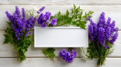 Purple Flowers And White Frame On Wooden Background