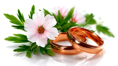 Two Gold Wedding Rings With Pink Flowers